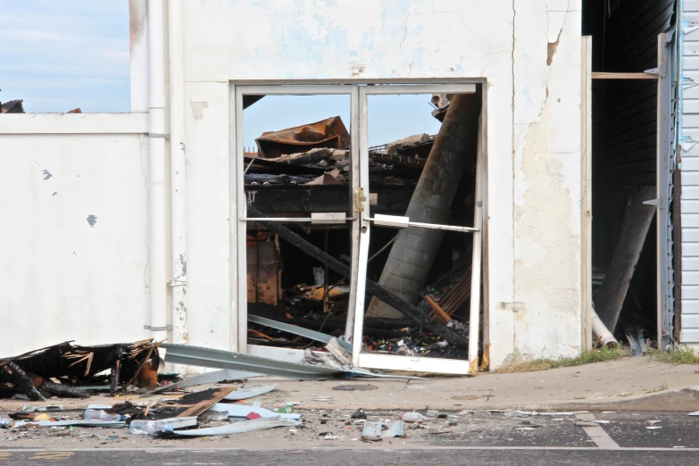 a window that has fallen open in front of an old building