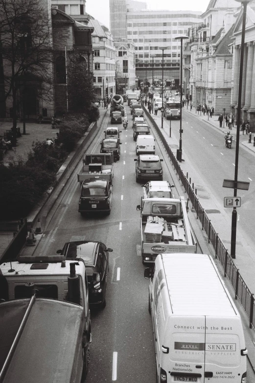 cars travel down a city street near a bus