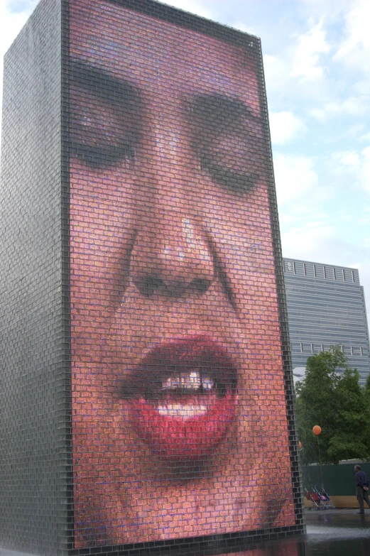 a giant display of images of marilyn monroe on a building