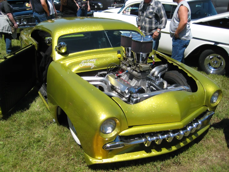 people viewing a vintage car show at the auto show