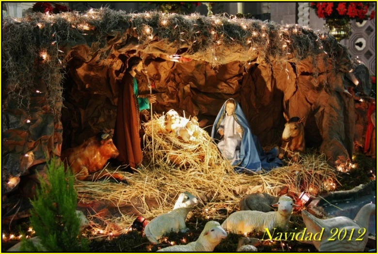 nativity scene with three sheep, christmas decorations and candles