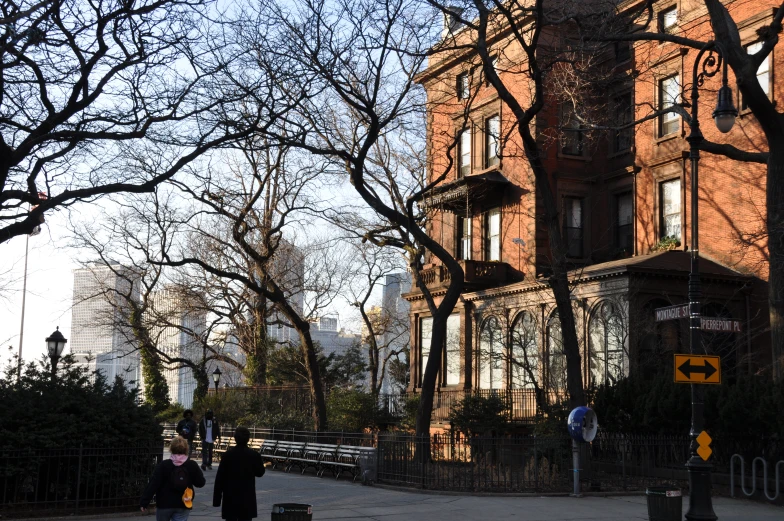 some tall buildings with people walking by on the street