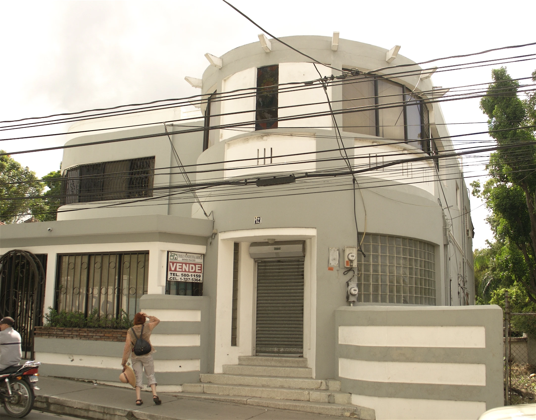 a large gray building with windows on the street