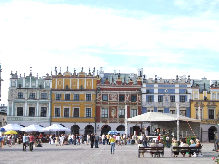 a group of people standing around outside of buildings