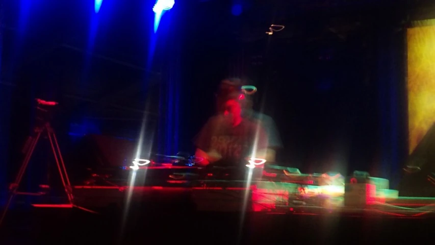 a dj and mixing equipment on a stage