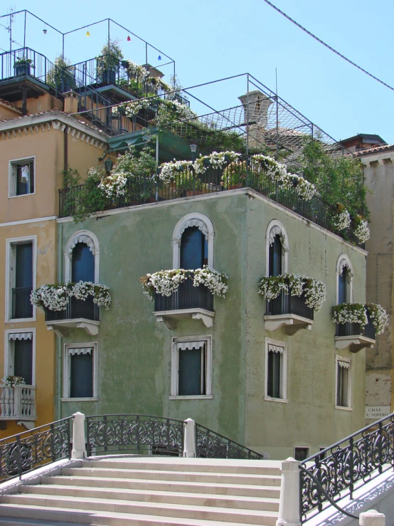 the building with white flowers on the balcony