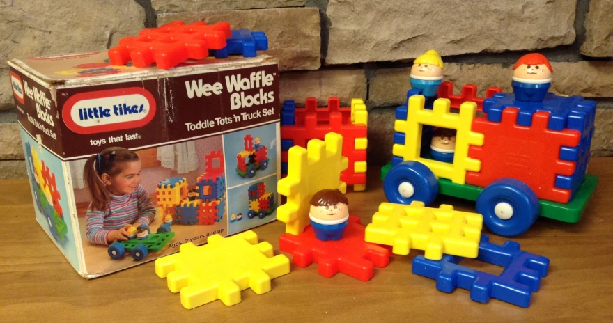 various toys sitting on the table with a small child in front