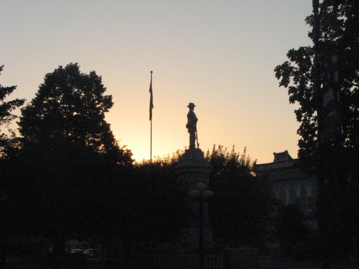 the sun is setting in the background behind the trees