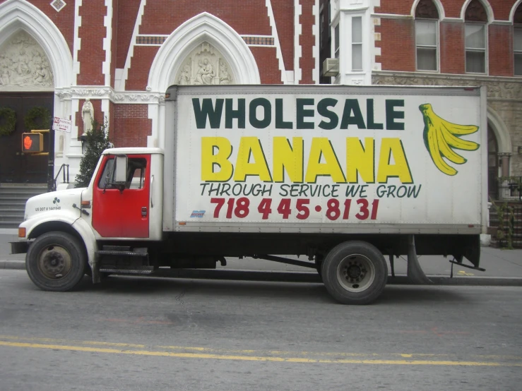 a truck is parked in front of a large building
