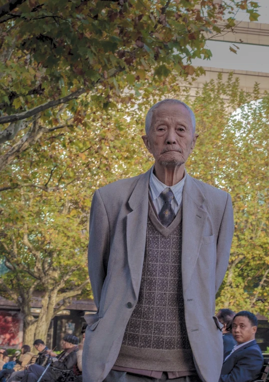 the statue is wearing a gray suit with a white shirt