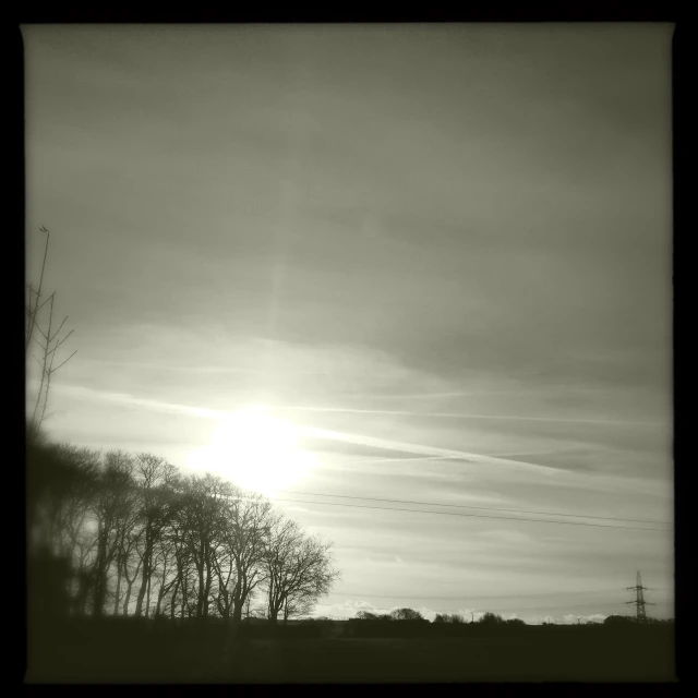 a black and white po with clouds in the background