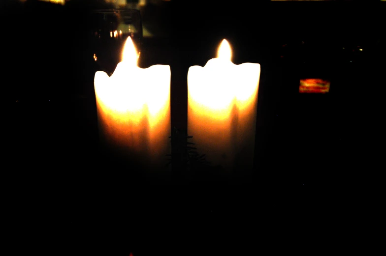 several candles with lite are sitting on a table