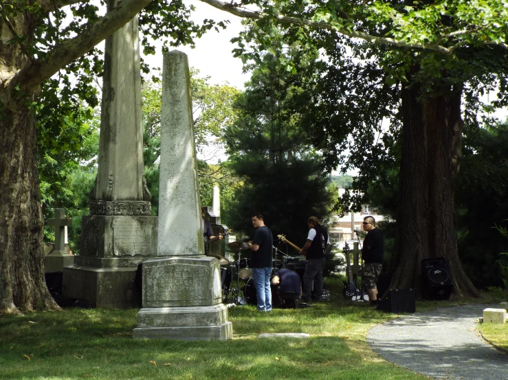 a group of men standing next to each other near trees