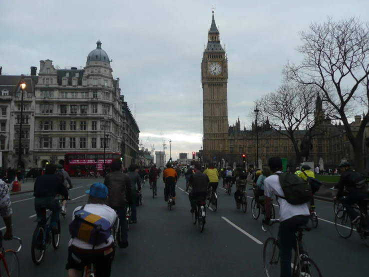 a bunch of people are riding their bikes down the street