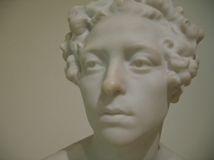 white statue with rose flowers in his hair