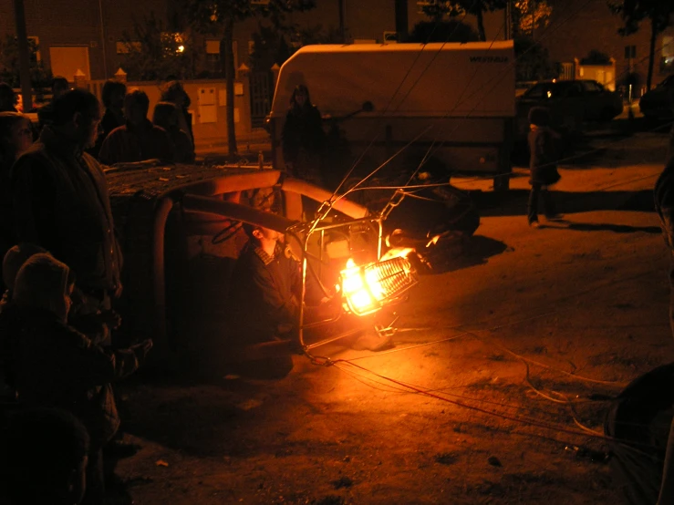 people sitting around and watching soing on the ground