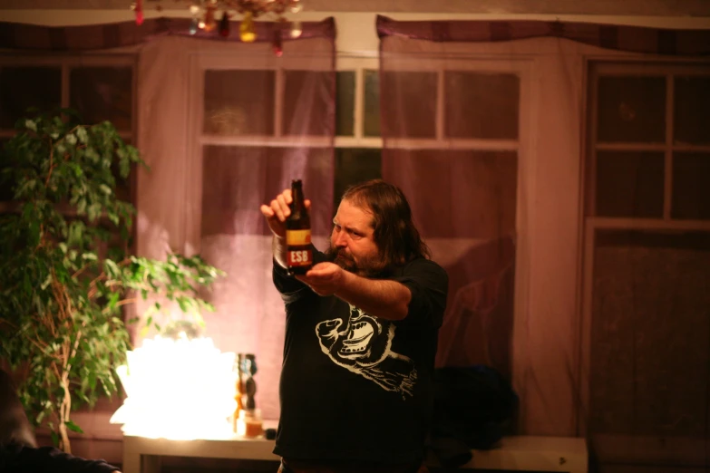 a man taking a picture with his phone in front of a living room window