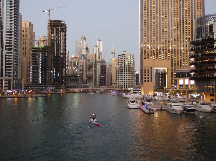 a man rows a boat through the water in an urban setting