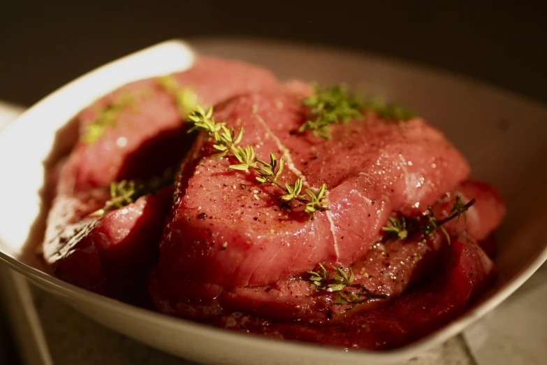 some meat in a bowl on top of a table