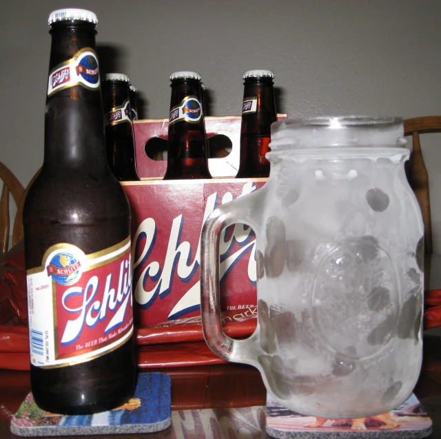 a table with two beer mugs and bottles on it