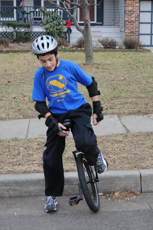 a  rides a bike on the side of a road