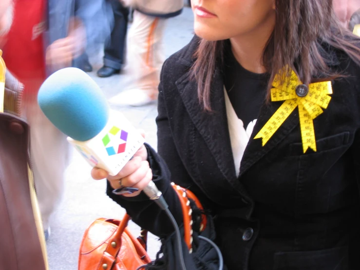 a woman is holding a microphone in her right hand
