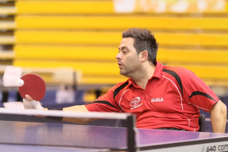 a man holding a ping pong paddle