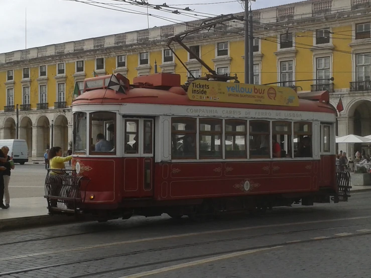 a trolley is traveling down a street in a foreign country