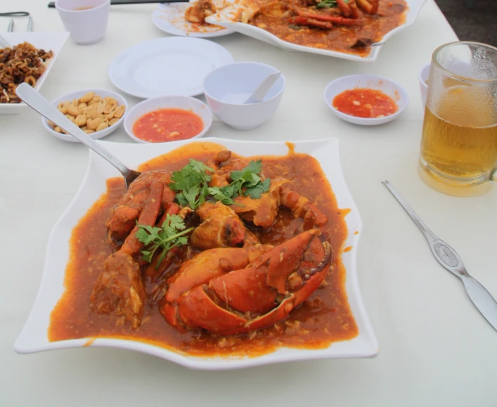 several plates and bowls with various different food items