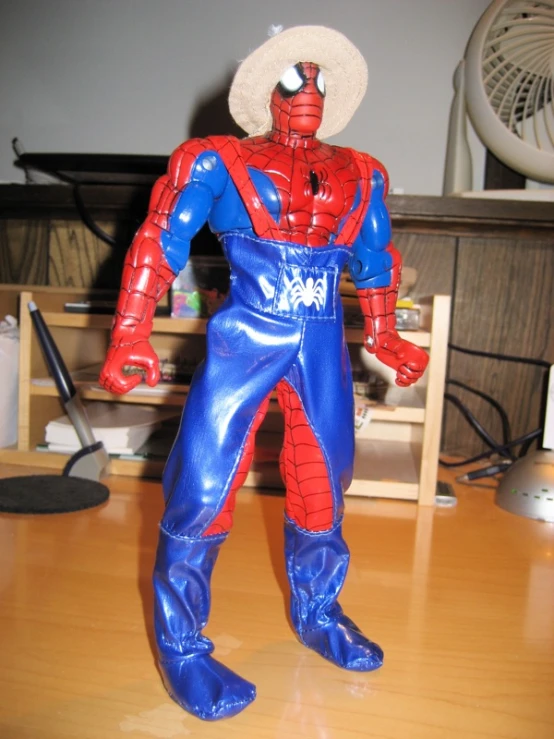 a plastic spider man standing on a desk