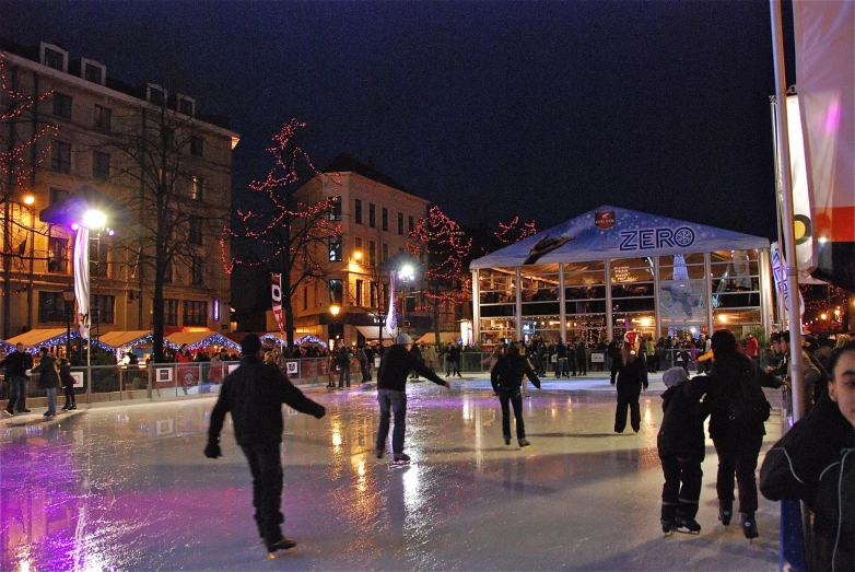 people skating in a ice rink in a small city