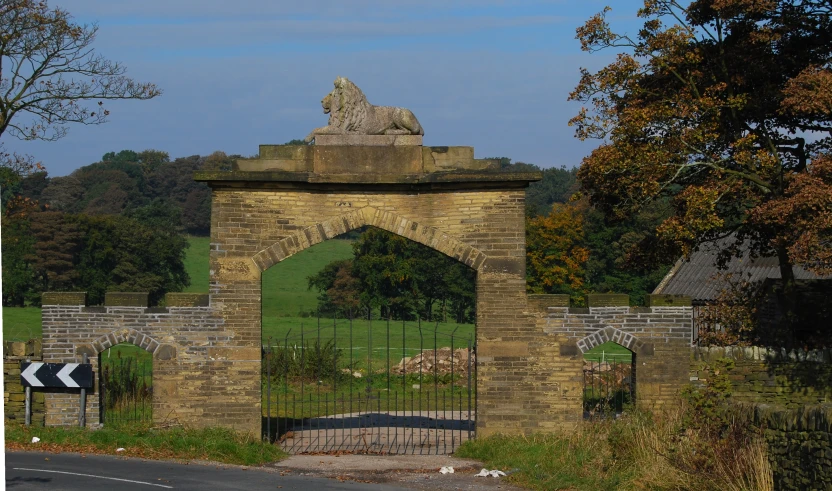 a large gate with a sculpture on top of it