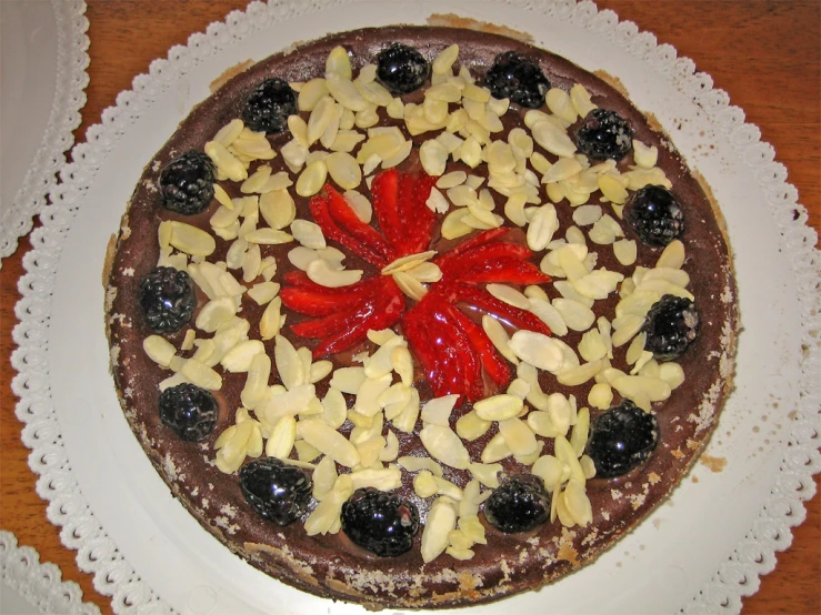 a round dessert has fruit on top and some chocolate