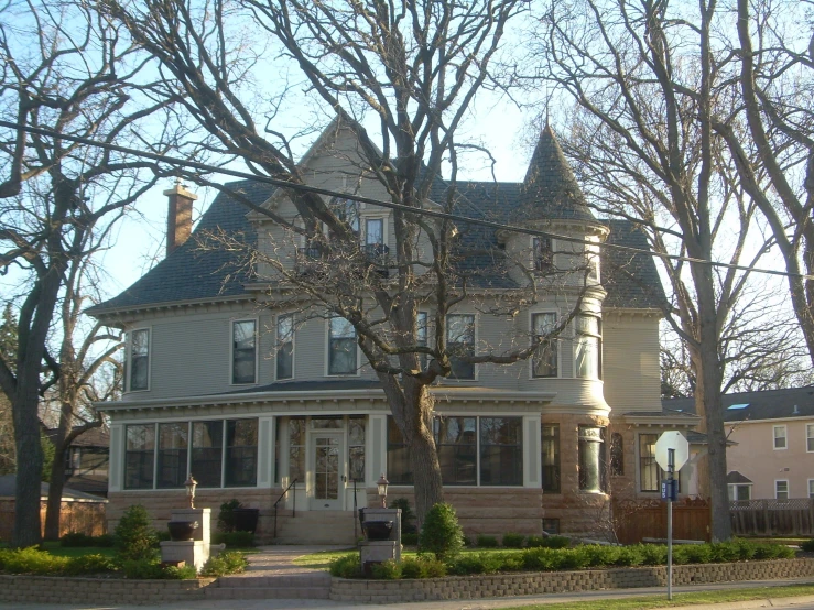 a big house sits in the corner of an intersection