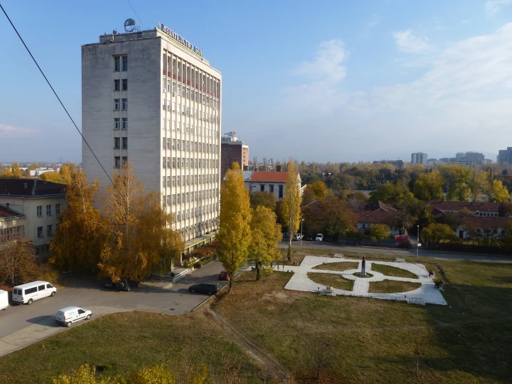 a large building surrounded by trees in the middle of it