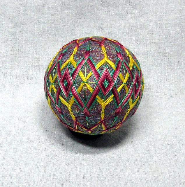 a bright colored ball is shown on a gray surface