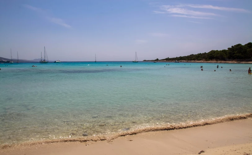 a large body of water sitting under a blue sky