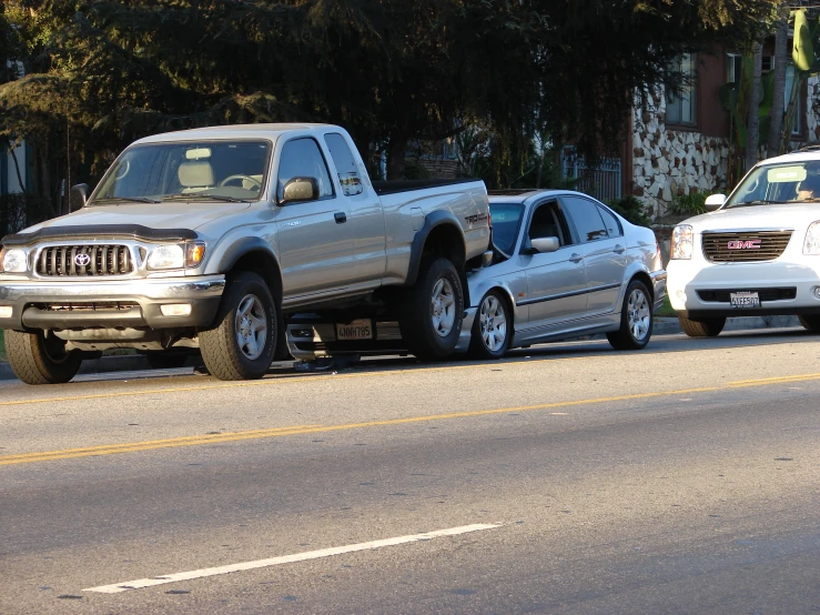 two toyota trucks that are parked next to each other