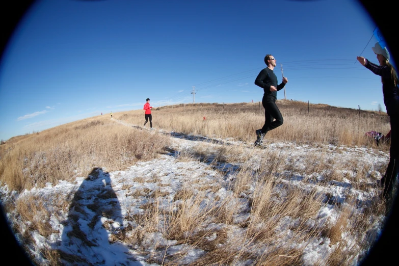 people running through the snow on the hills