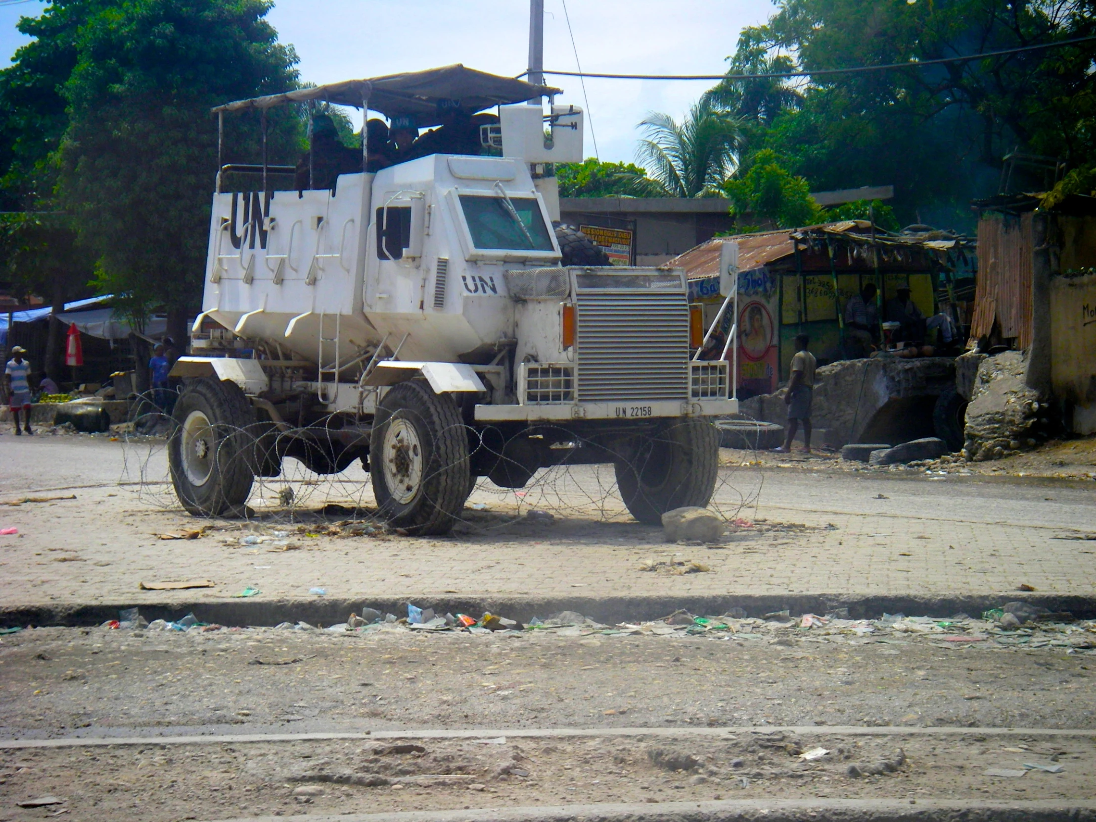 truck parked in a dirt lot near buildings