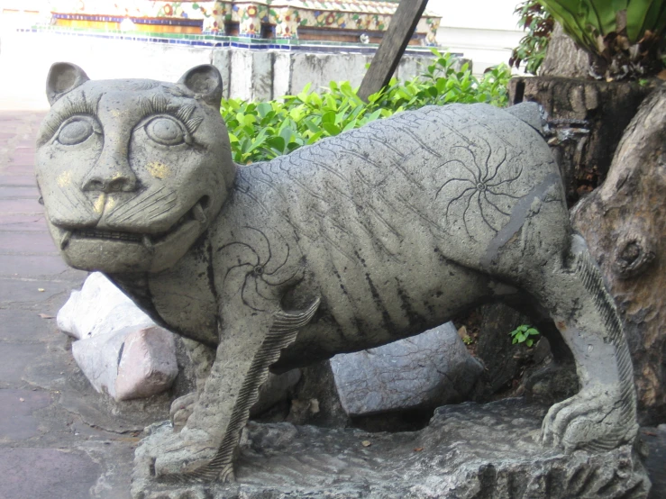 a statue that is sitting next to a tree