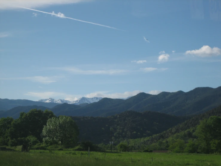 a scenic view of trees and mountains under a clear sky