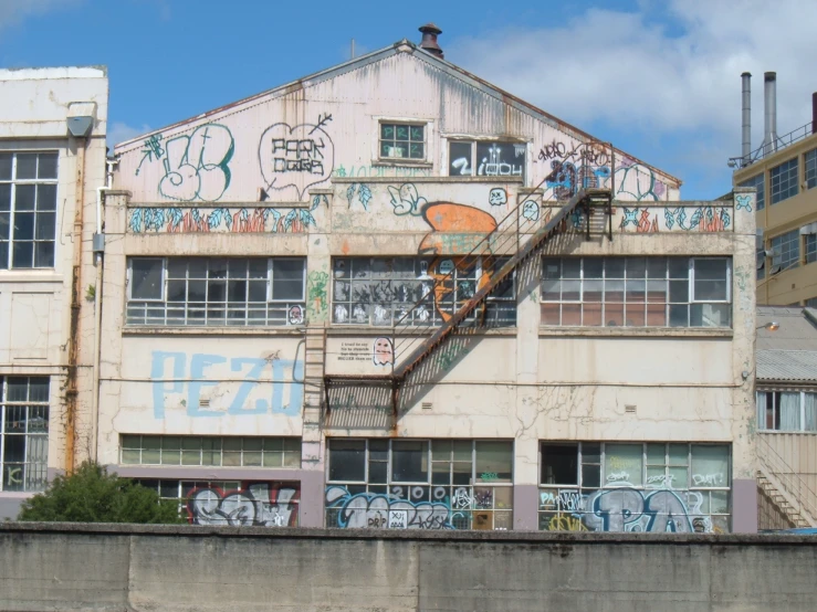 the staircase is near some graffiti in a run down building