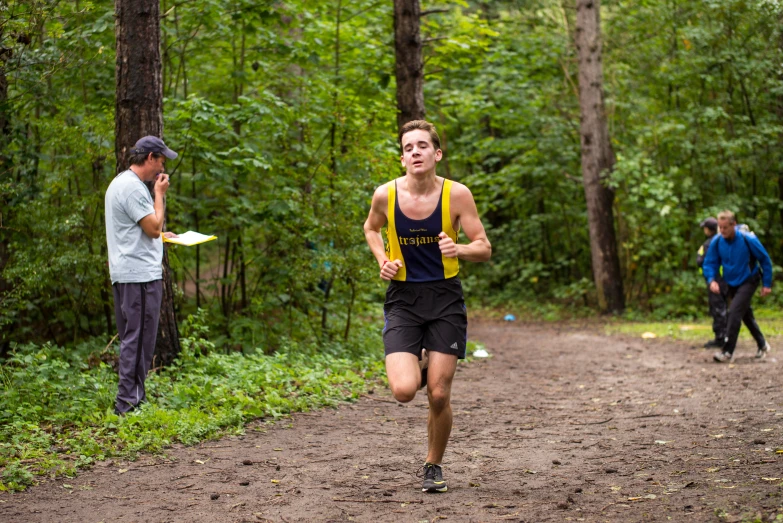 a man runs down the road and another man in the distance