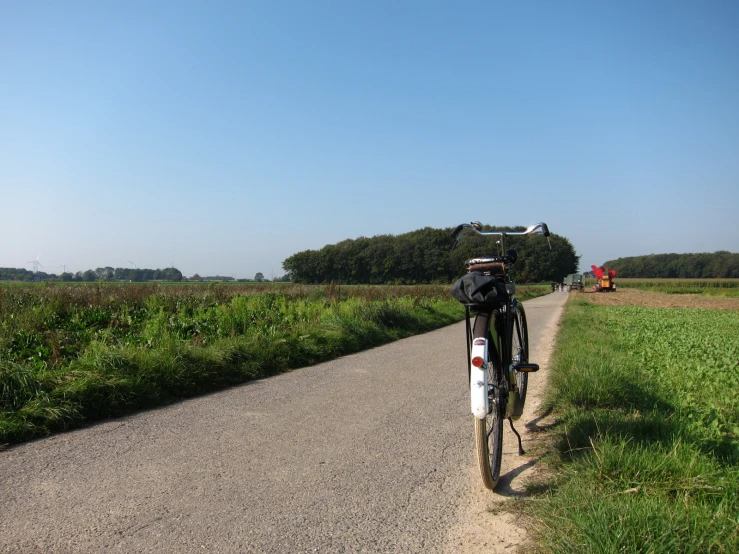 a bike leaning on the side of a road