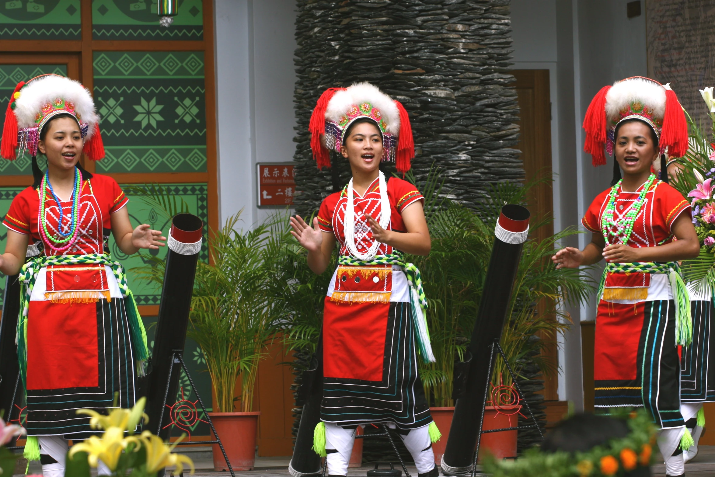 three women in elaborate clothing performing a dance