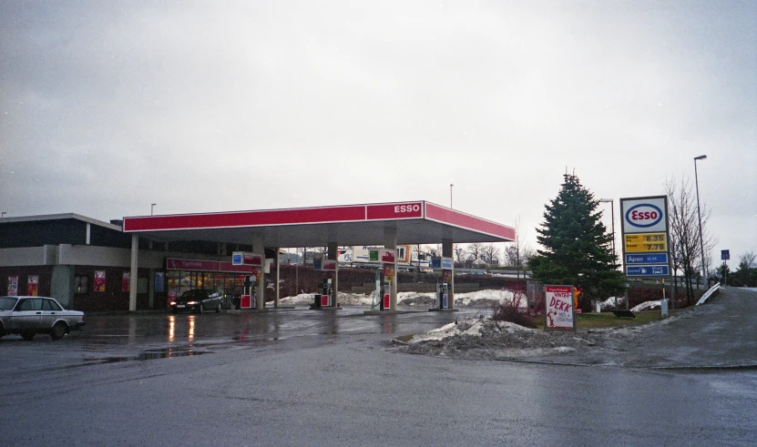 a gas station with snow in front of it