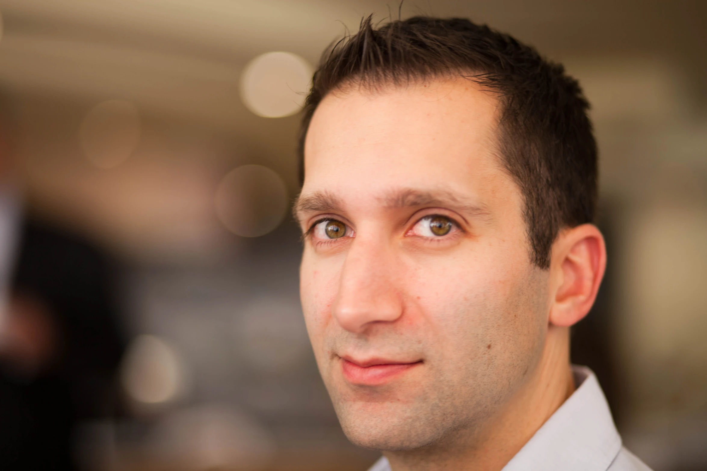 a man in a white shirt looking straight ahead