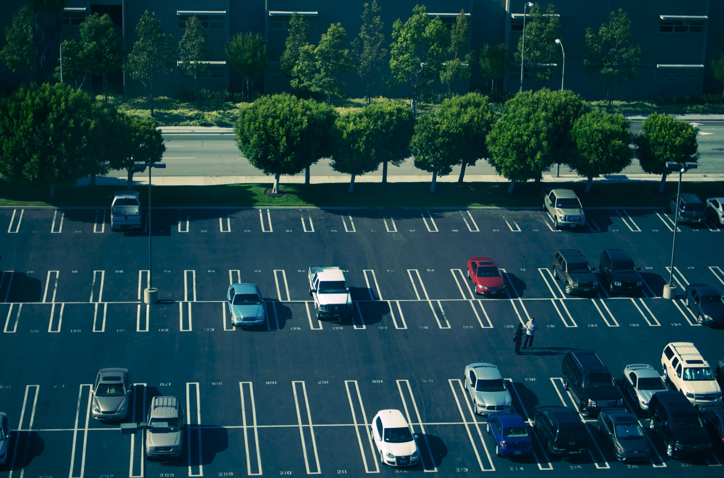 an overhead s of a parking lot with cars parked