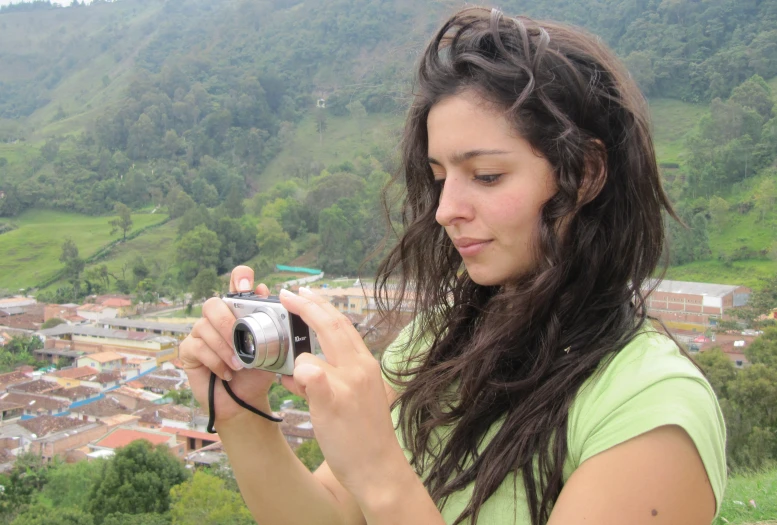 woman with long hair takes po on mountain